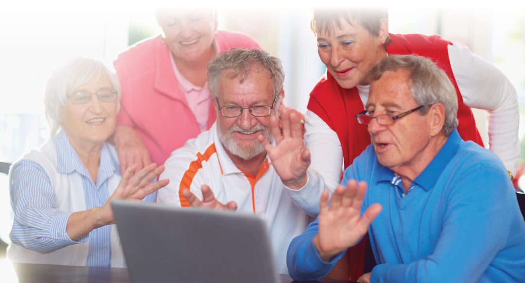 Senior friends having a video conference at laptop